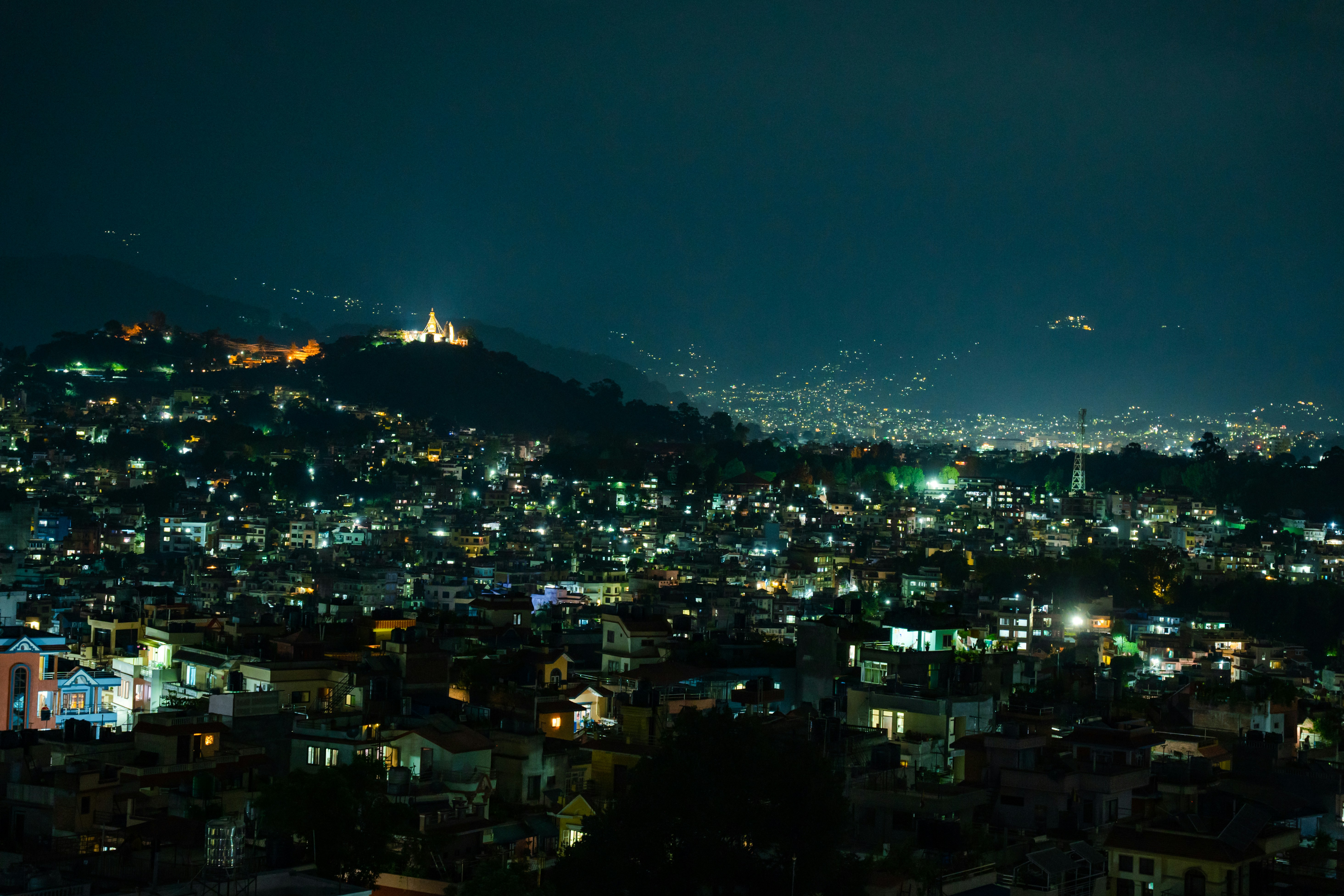 Kathmandu city during the night and Swayambhunath temple.