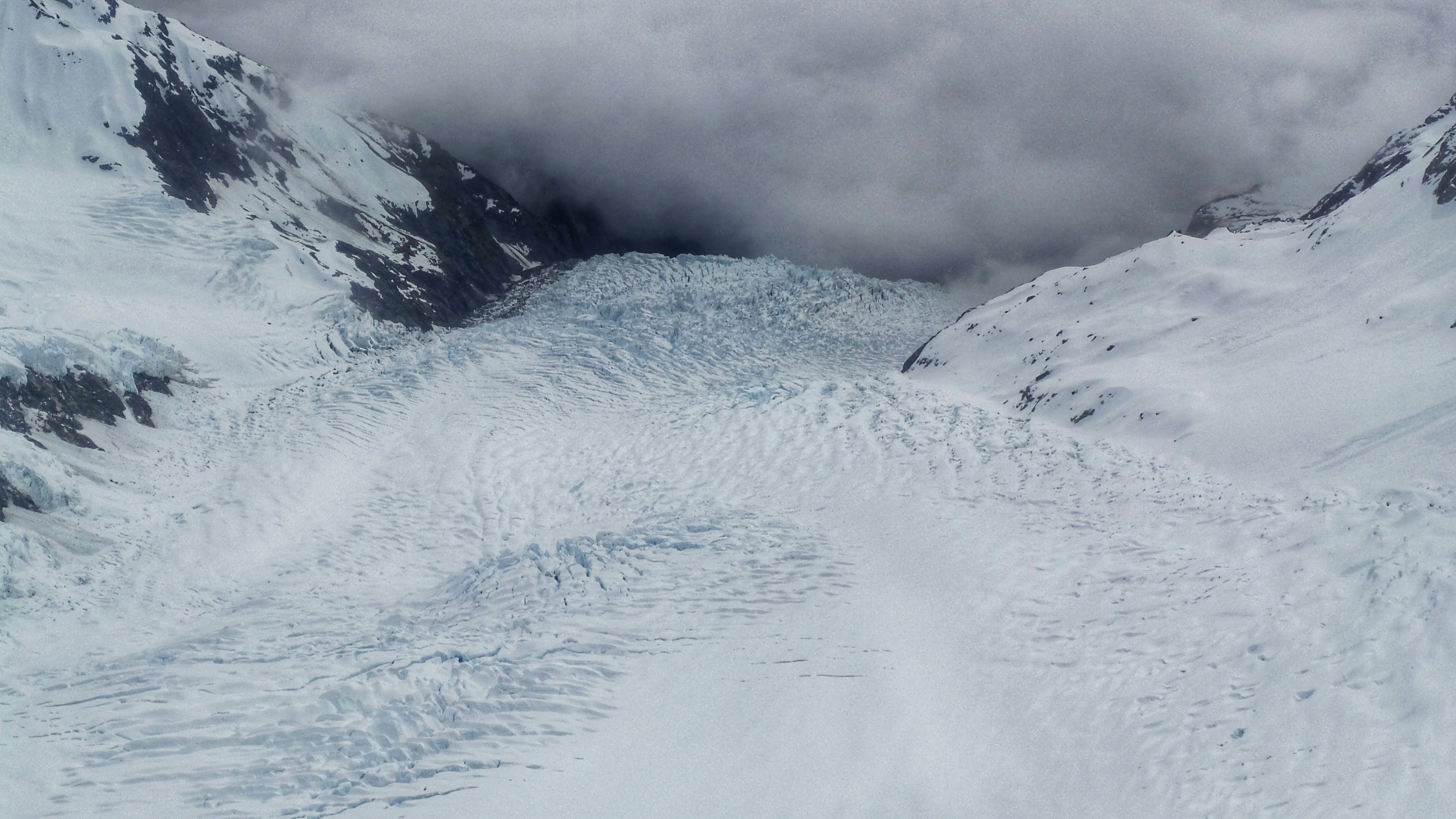 An aerial view from a plane onto the Franz Josef Glacier into the mist. Franz Josef Glacier, New Zealand