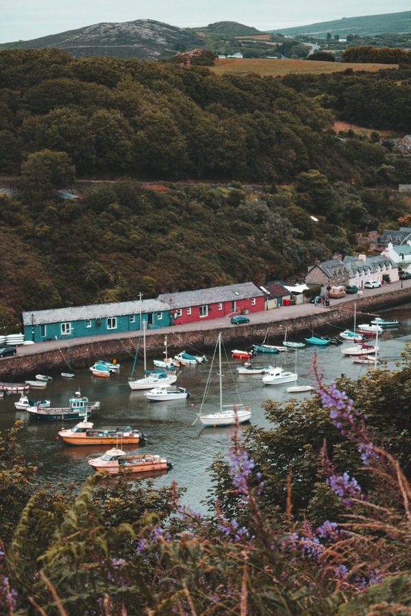 Boats docked on the water in the seaside town of Fishguard, Wales UK