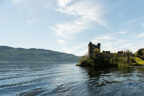 Urquhart Castle in Scotland with Loch Ness next to it