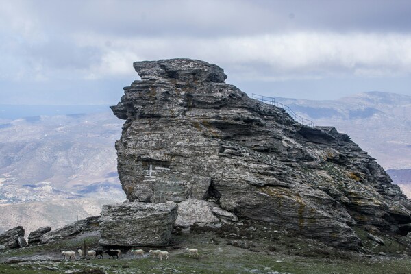 The Profitis Ilias Peak on the island of Andros, Greece. A flock of sheep.