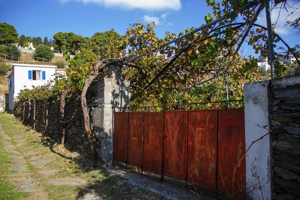 The inscription L.O.V.E over a rusty gate of a farm